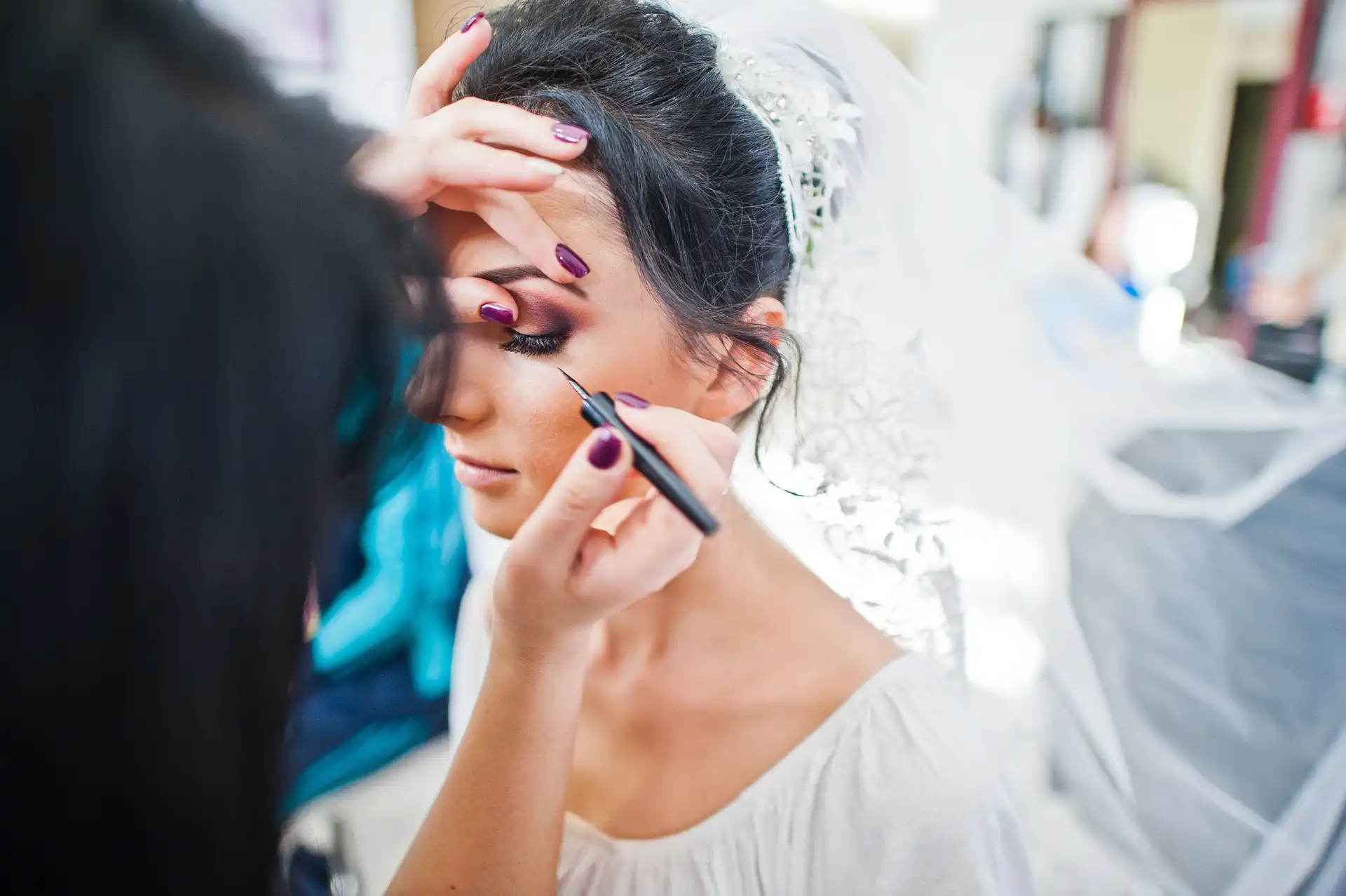 Bridal makeup artist applying makeup to a bride